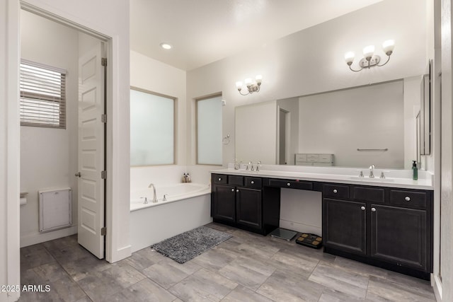 bathroom with a tub to relax in and vanity