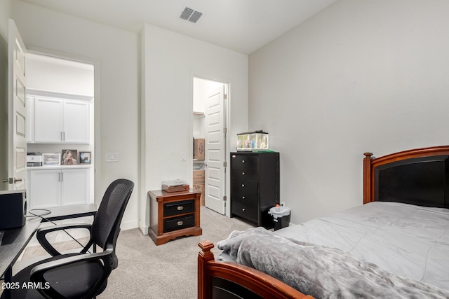 bedroom featuring light carpet