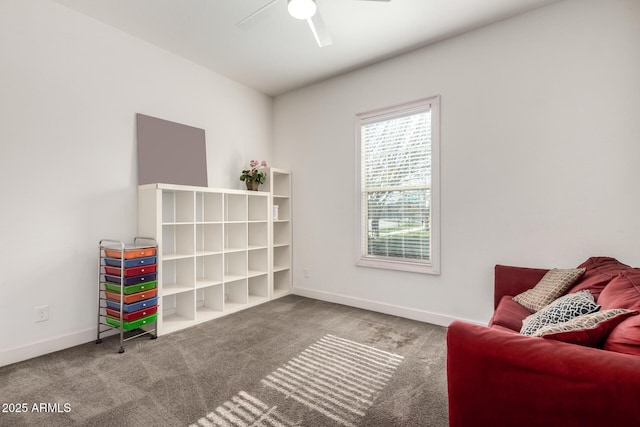 living area featuring carpet floors and ceiling fan