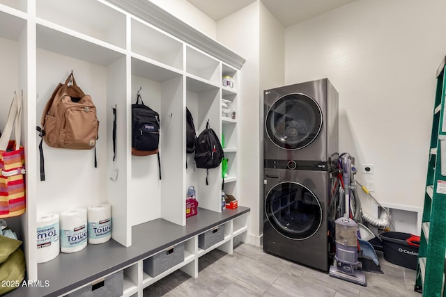 mudroom with stacked washer and clothes dryer