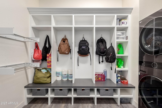 mudroom featuring hardwood / wood-style floors and stacked washer and clothes dryer