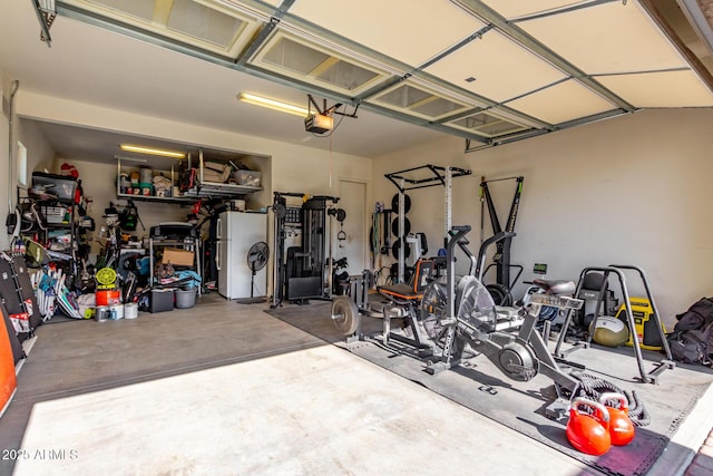 garage with white fridge and a garage door opener