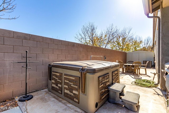 view of patio with a storage unit