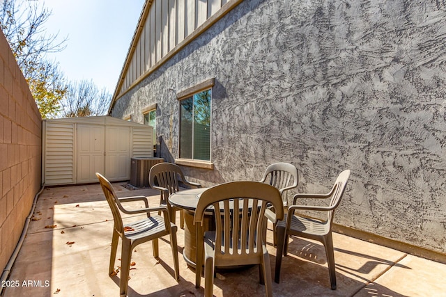 view of patio featuring a storage unit