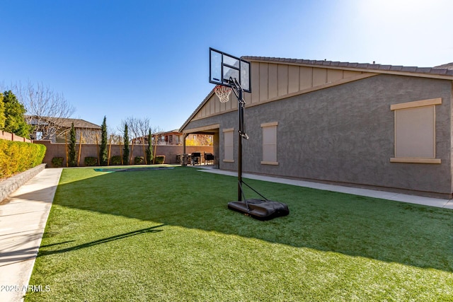 view of sport court featuring a yard