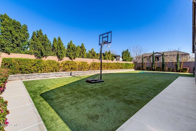 view of yard with basketball court