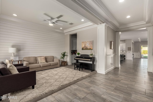 living room with ornamental molding, ceiling fan, and ornate columns