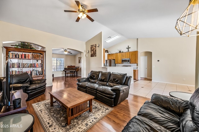 8479 E Sunrise Sky Dr, Gold Canyon, AZ 85118 - living room featuring vaulted ceiling, ceiling fan with notable chandelier, and light wood-type flooring