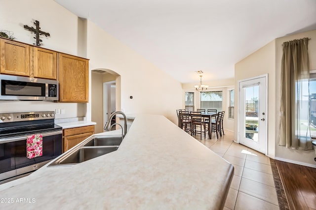 8479 E Sunrise Sky Dr, Gold Canyon, AZ 85118 - kitchen with vaulted ceiling, pendant lighting, sink, light tile patterned floors, and stainless steel appliances