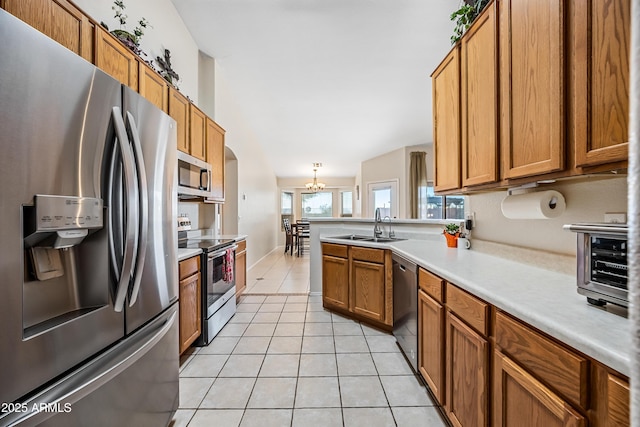 8479 E Sunrise Sky Dr, Gold Canyon, AZ 85118 - kitchen featuring appliances with stainless steel finishes, decorative light fixtures, sink, light tile patterned floors, and a notable chandelier