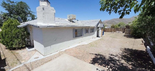 452 W Ray St, Superior, AZ 85173 - view of side of property featuring a chimney, fence, stucco siding, and cooling unit