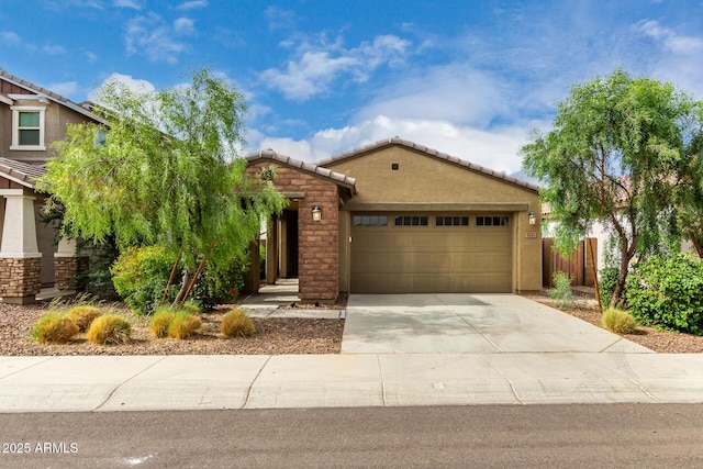 9222 W Roma Ave, Phoenix, AZ 85037 - view of front of home with a tile roof, an attached garage, concrete driveway, and stucco siding