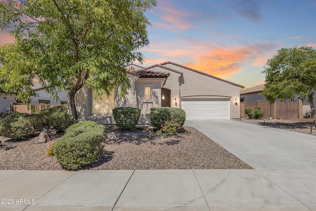 31332 N 137th Ln, Peoria, AZ 85383 - mediterranean / spanish home featuring an attached garage, stucco siding, concrete driveway, and a tile roof