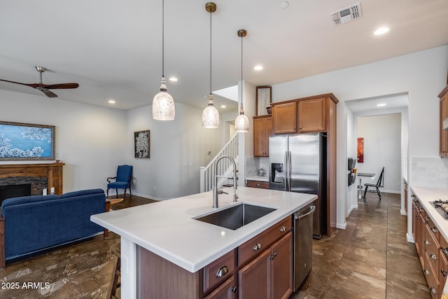 31332 N 137th Ln, Peoria, AZ 85383 - kitchen with open floor plan, a ceiling fan, light countertops, a fireplace, and recessed lighting