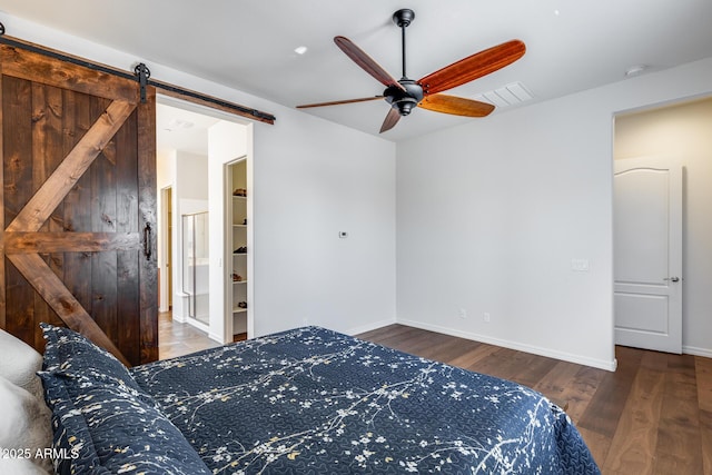31332 N 137th Ln, Peoria, AZ 85383 - bedroom with a barn door, wood finished floors, and a ceiling fan