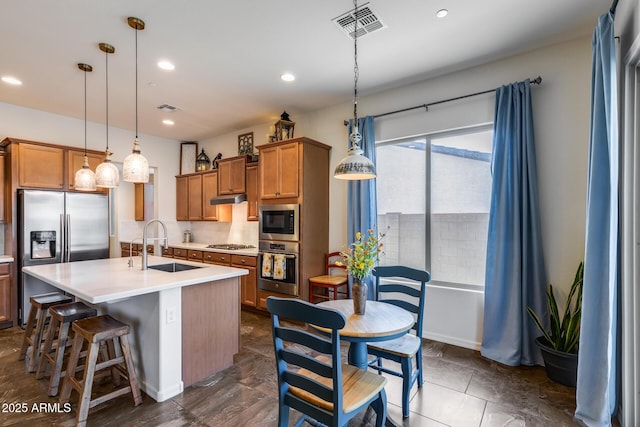 31332 N 137th Ln, Peoria, AZ 85383 - kitchen with appliances with stainless steel finishes, brown cabinetry, backsplash, light countertops, and recessed lighting