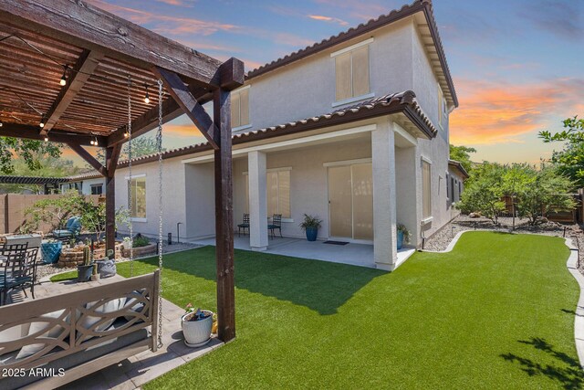 31332 N 137th Ln, Peoria, AZ 85383 - back of house at dusk with a pergola, stucco siding, a patio, and a tile roof