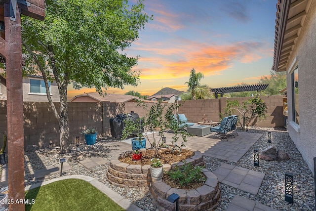 31332 N 137th Ln, Peoria, AZ 85383 - patio terrace at dusk with a patio area, a fenced backyard, and an outdoor fire pit