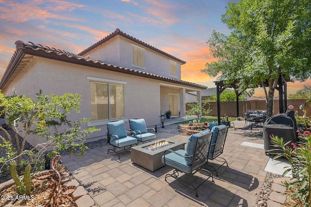 31332 N 137th Ln, Peoria, AZ 85383 - patio terrace at dusk with a patio, outdoor dining space, and an outdoor living space with a fire pit