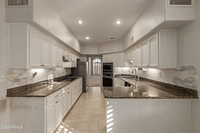 kitchen featuring white cabinetry, sink, kitchen peninsula, dark stone counters, and black appliances