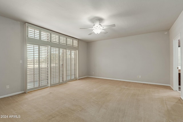 interior space featuring ceiling fan and light colored carpet