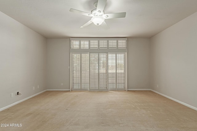 unfurnished room with ceiling fan and light carpet