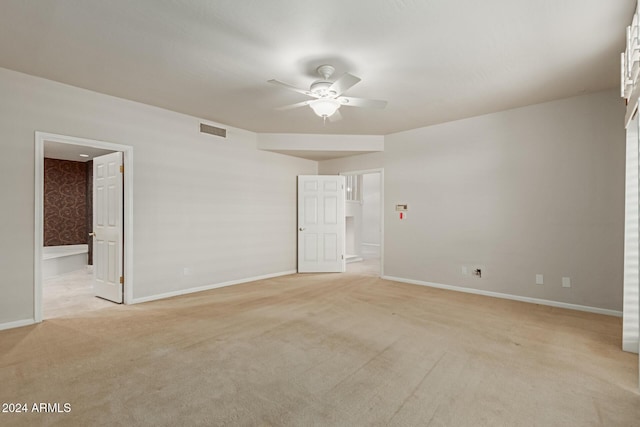 unfurnished room featuring ceiling fan and light colored carpet