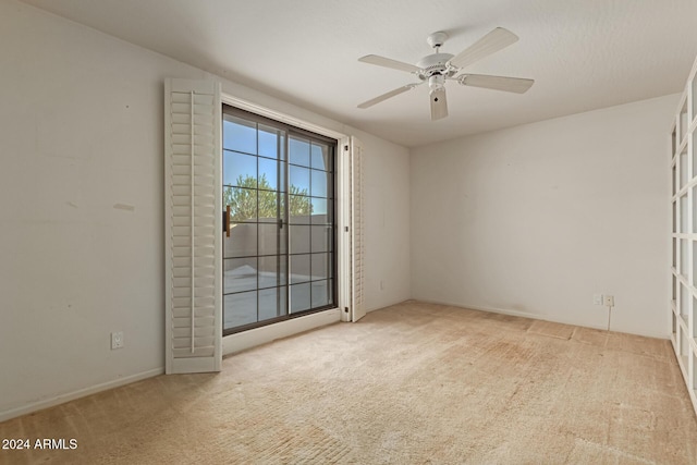 unfurnished room featuring light carpet and ceiling fan