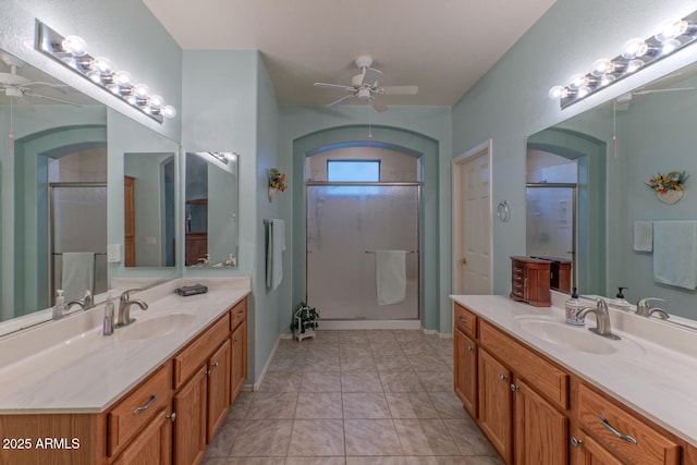 bathroom with vanity, ceiling fan, tile patterned flooring, and walk in shower