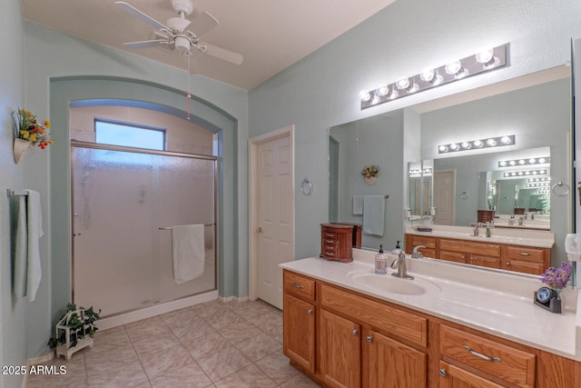 bathroom featuring ceiling fan, walk in shower, vanity, and tile patterned flooring