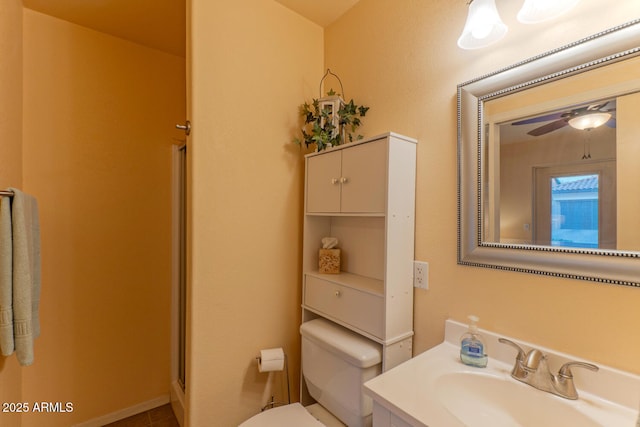 bathroom featuring ceiling fan, vanity, and toilet