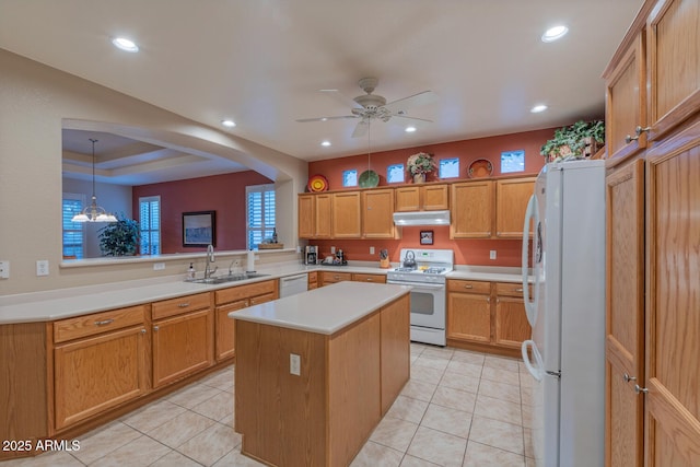 kitchen with decorative light fixtures, a center island, sink, white appliances, and ceiling fan with notable chandelier