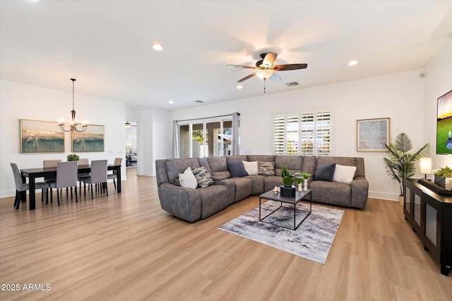 living room featuring recessed lighting, visible vents, light wood-style floors, and ceiling fan with notable chandelier