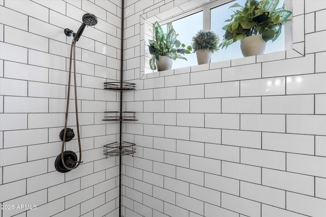 bathroom with a tile shower