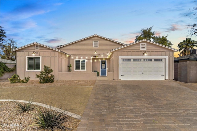 single story home with an attached garage and decorative driveway
