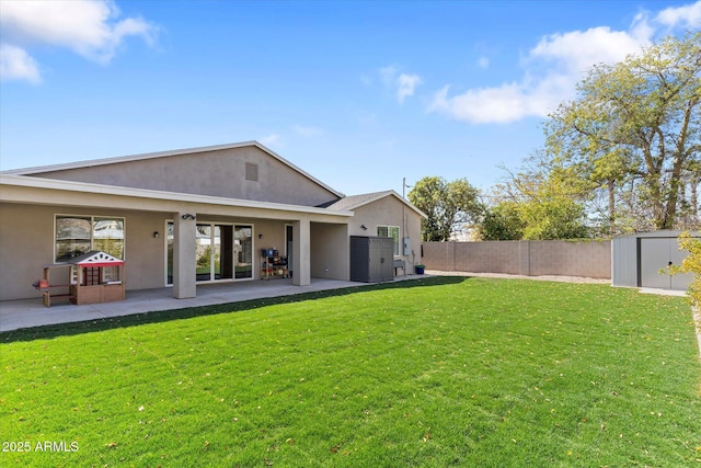 back of property with stucco siding, fence, a storage shed, an outdoor structure, and a patio area