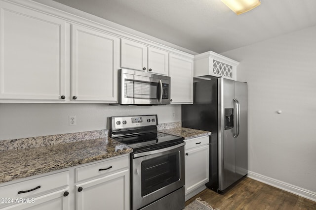 kitchen featuring white cabinets, dark stone counters, and appliances with stainless steel finishes