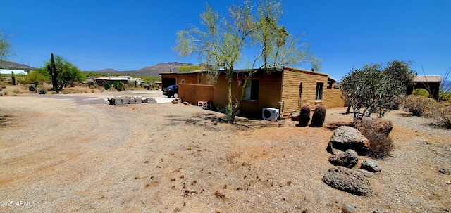 9607 E Mckellips Rd, Mesa, AZ 85207 - view of property exterior with a mountain view and a cooling unit