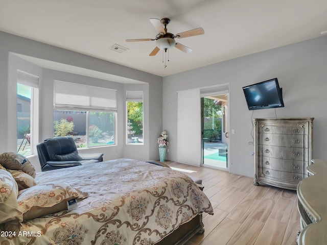 bedroom featuring access to outside, light hardwood / wood-style floors, and ceiling fan