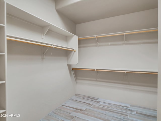 spacious closet featuring light hardwood / wood-style floors