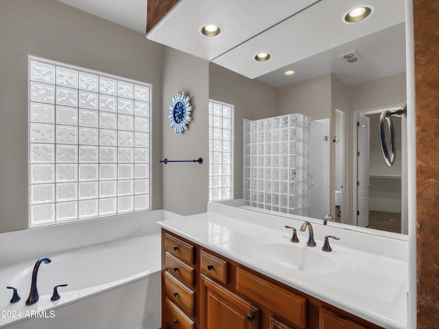 bathroom with a bath and vanity