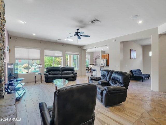 tiled living room with ceiling fan