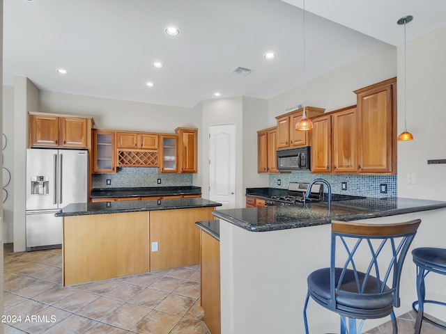 kitchen featuring stainless steel appliances, hanging light fixtures, a breakfast bar, and kitchen peninsula