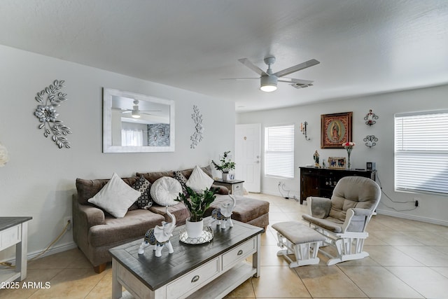 living area featuring light tile patterned floors, visible vents, and a ceiling fan