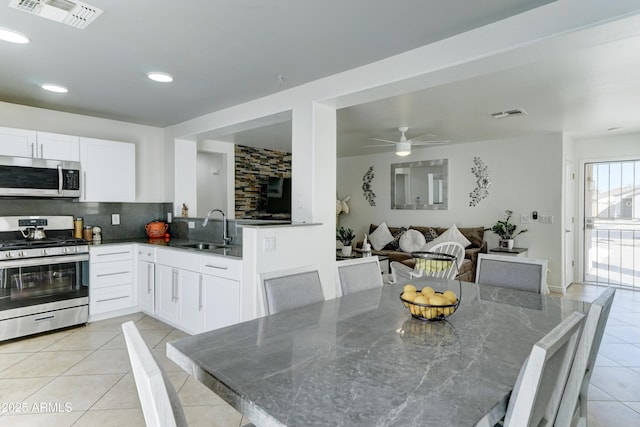 dining room with light tile patterned floors, ceiling fan, visible vents, and recessed lighting