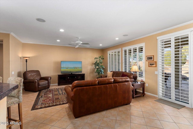 living room with light tile patterned floors, ceiling fan, and ornamental molding