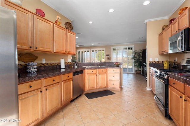 kitchen with kitchen peninsula, ornamental molding, stainless steel appliances, sink, and light tile patterned flooring