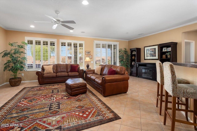 living room with light tile patterned floors, ceiling fan, and ornamental molding