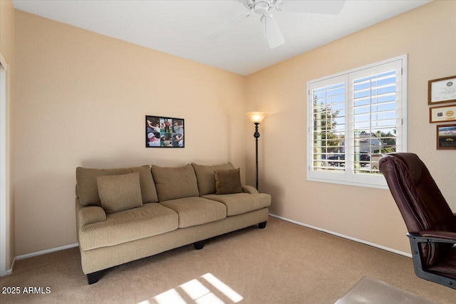 carpeted living room featuring ceiling fan