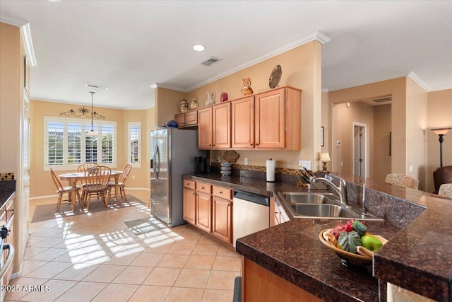 kitchen with sink, light tile patterned floors, ornamental molding, appliances with stainless steel finishes, and decorative light fixtures